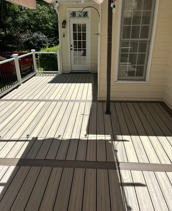 Two tone composite deck with white railing and black balusters, built by The handyman in Griffin, GA