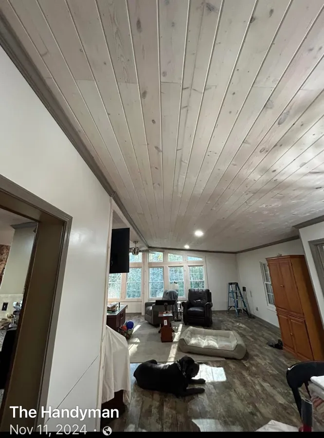 Interior remodel with a whitewashed plank ceiling by The handyman